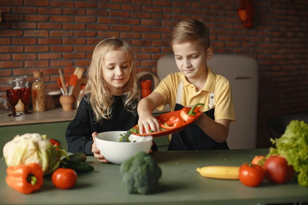 Kids making healthy dish together.