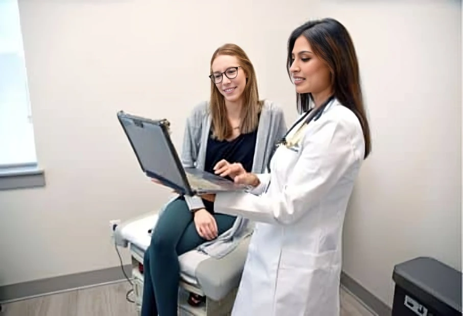 Doctor and patient reviewing electronic records.