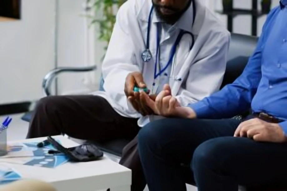 Doctor conducting diabetes blood glucose test.