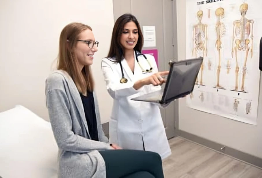 Physician showing digital information to patient.