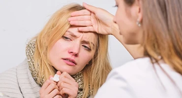 Doctor checking patient temperature.