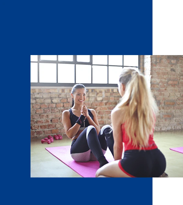 Women smiling during fitness class.