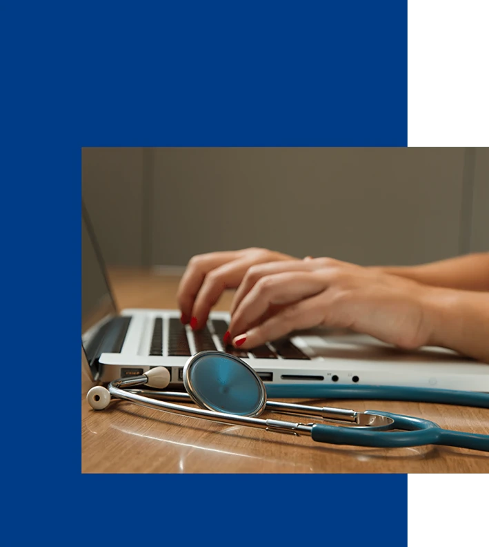 Medical professional working on laptop.