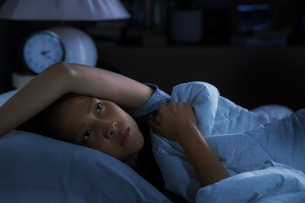 Woman lying awake in bed